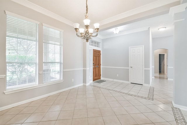 unfurnished room featuring an inviting chandelier, light tile patterned flooring, and ornamental molding