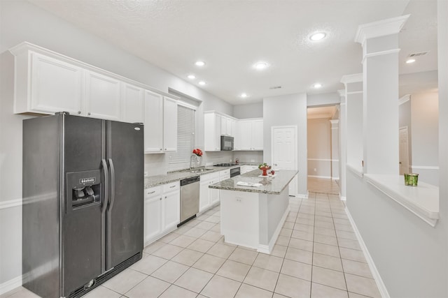 kitchen featuring black appliances, white cabinets, light tile patterned floors, a kitchen island, and light stone counters