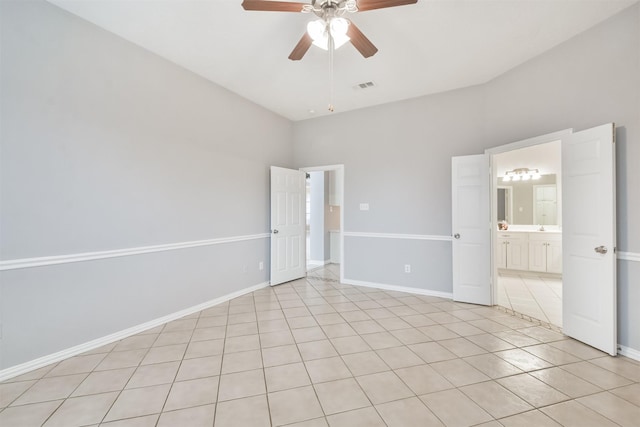 tiled empty room featuring ceiling fan and lofted ceiling