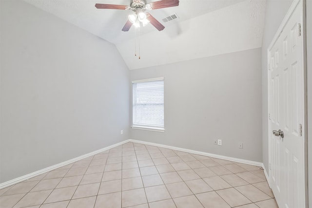 empty room featuring light tile patterned floors, ceiling fan, and lofted ceiling