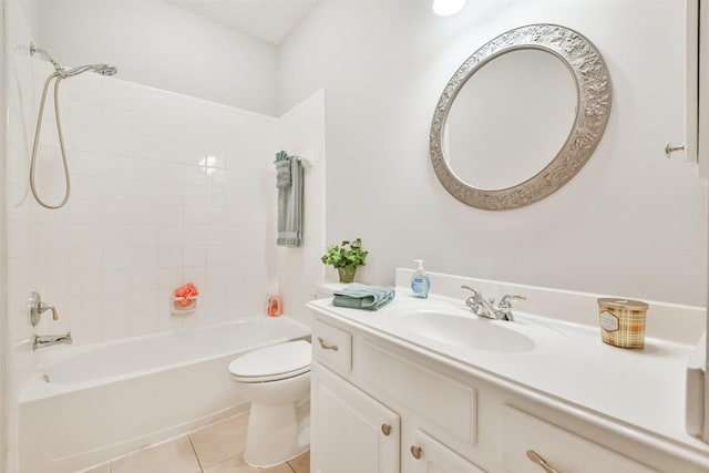 full bathroom featuring tile patterned floors, vanity, tiled shower / bath, and toilet