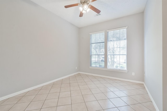 tiled spare room with ceiling fan and a wealth of natural light