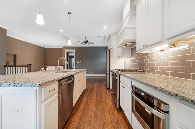 kitchen featuring sink, hanging light fixtures, hardwood / wood-style flooring, ceiling fan, and appliances with stainless steel finishes