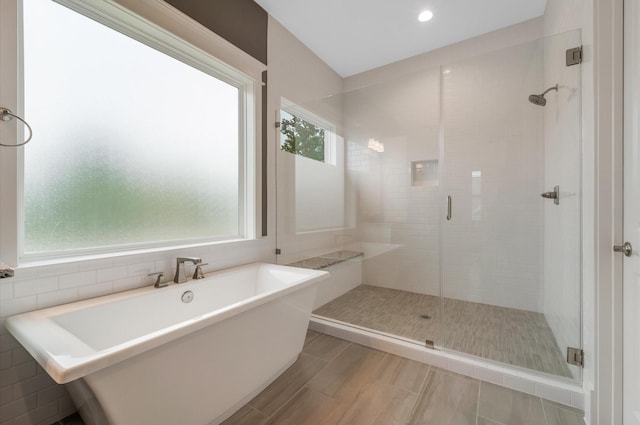 bathroom with shower with separate bathtub