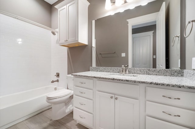 full bathroom featuring vanity, bathtub / shower combination, and toilet