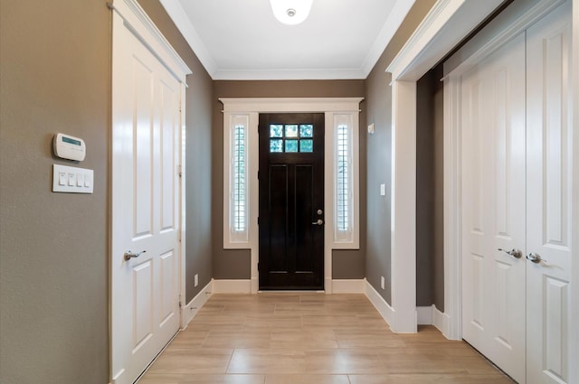 foyer featuring crown molding