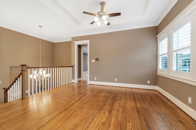 unfurnished room featuring hardwood / wood-style floors, ceiling fan with notable chandelier, and crown molding