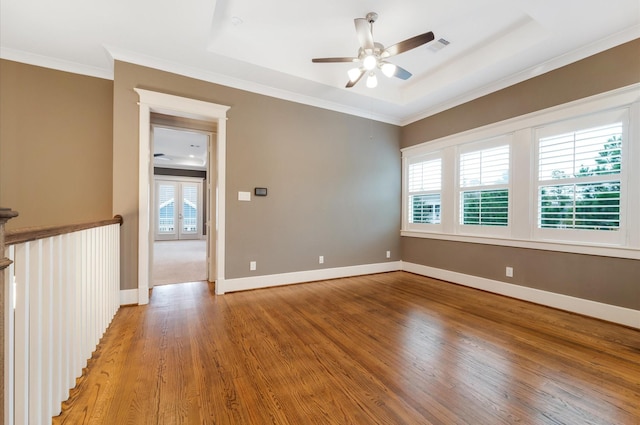 unfurnished room featuring hardwood / wood-style flooring, ceiling fan, and a healthy amount of sunlight