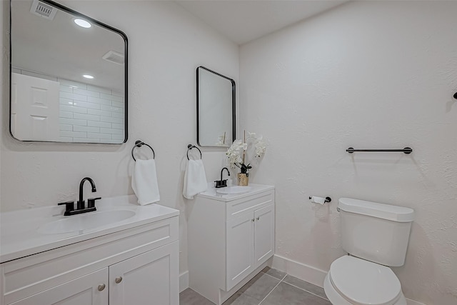 bathroom featuring vanity, tile patterned floors, and toilet