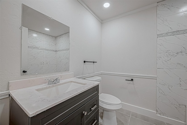 bathroom featuring toilet, ornamental molding, tile patterned floors, and vanity