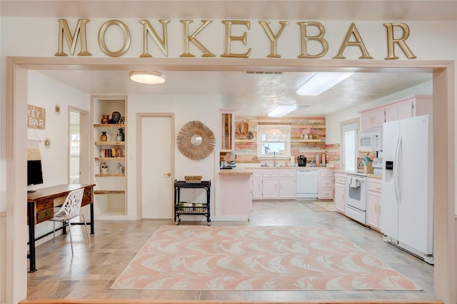 kitchen featuring open shelves, light countertops, white appliances, white cabinetry, and a sink