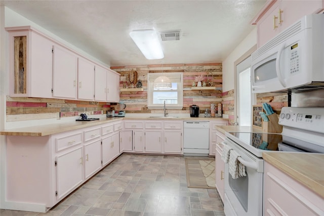 kitchen featuring white cabinets, white appliances, backsplash, and sink