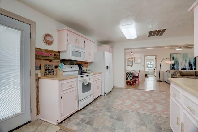 kitchen featuring white cabinets, white appliances, and ceiling fan