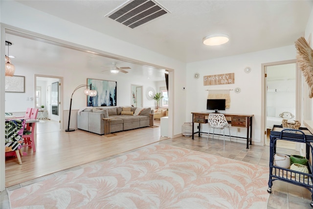 living room featuring light hardwood / wood-style floors and ceiling fan