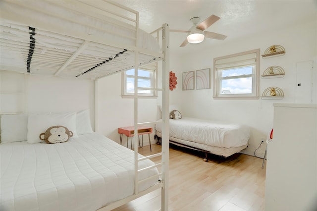 bedroom with ceiling fan and hardwood / wood-style flooring