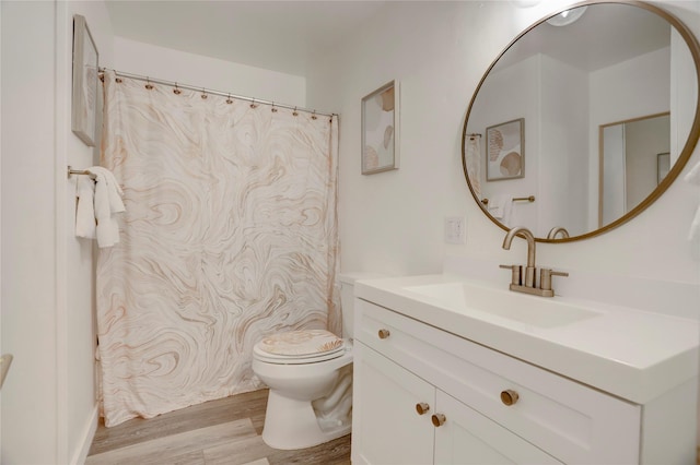 bathroom with vanity, hardwood / wood-style flooring, and toilet