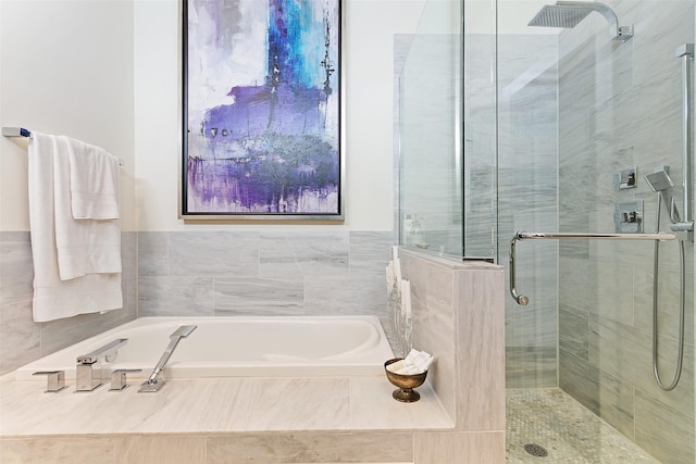 full bathroom with a garden tub and a shower stall