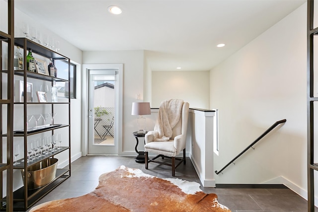 sitting room featuring baseboards, tile patterned floors, an upstairs landing, and recessed lighting