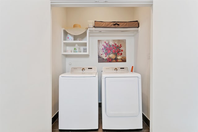 washroom featuring dark tile patterned flooring and washing machine and clothes dryer