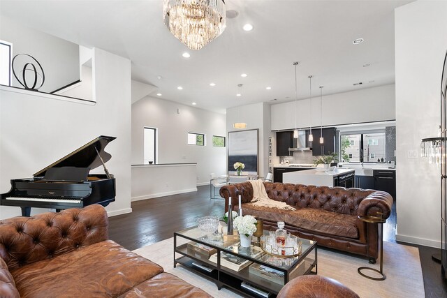 living room with wood-type flooring and an inviting chandelier