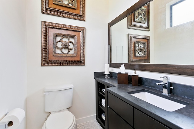 half bath featuring toilet, baseboards, and vanity