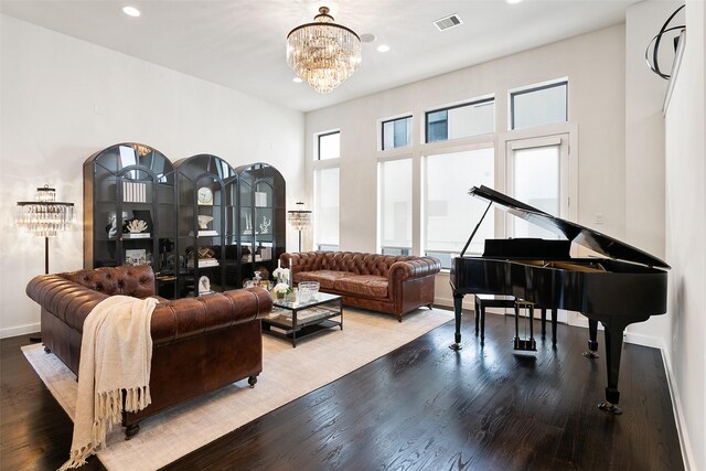 living room featuring hardwood / wood-style floors, an inviting chandelier, and a healthy amount of sunlight