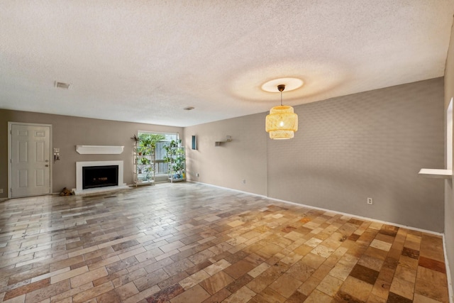 unfurnished living room with a textured ceiling