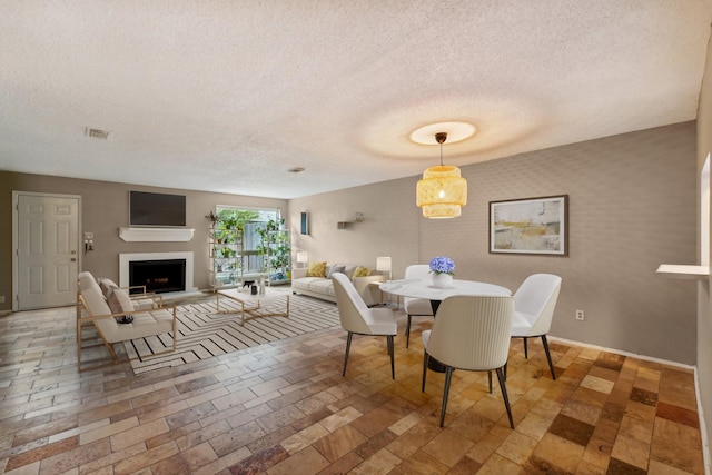 dining space featuring a textured ceiling