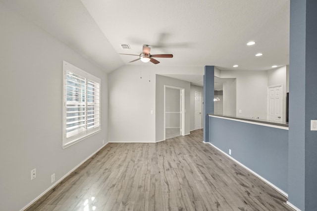 unfurnished living room featuring light hardwood / wood-style flooring, ceiling fan, and lofted ceiling