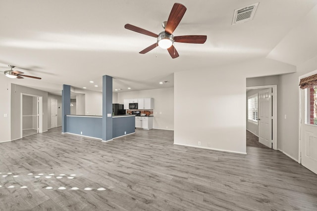 unfurnished living room with ceiling fan, light hardwood / wood-style flooring, and lofted ceiling