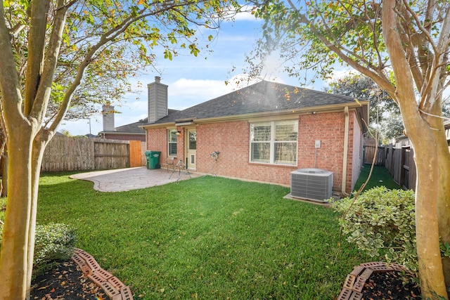 back of property featuring central air condition unit, a patio area, and a yard