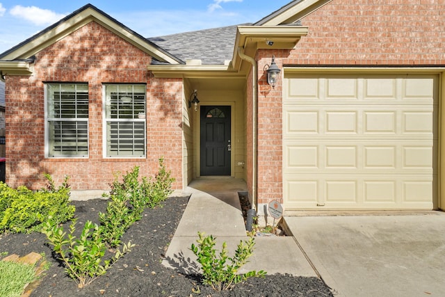 doorway to property with a garage