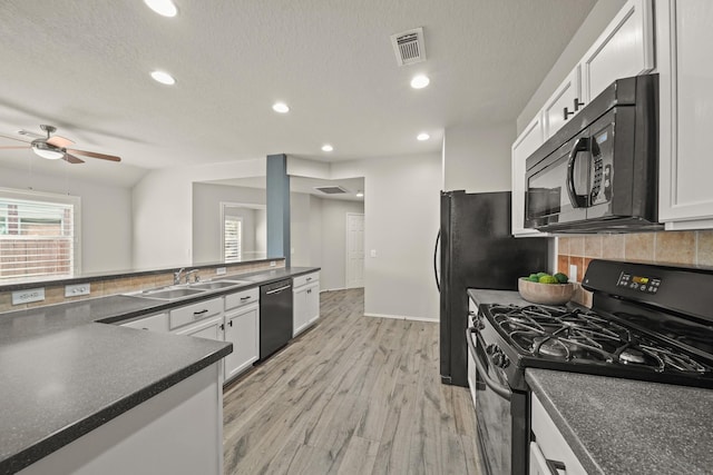 kitchen featuring white cabinets, a textured ceiling, gas stove, sink, and dishwasher