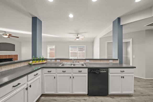 kitchen with sink, white cabinetry, black dishwasher, and light wood-type flooring