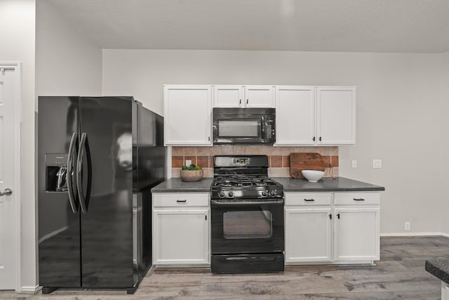 kitchen featuring white cabinetry, tasteful backsplash, light hardwood / wood-style flooring, a textured ceiling, and black appliances