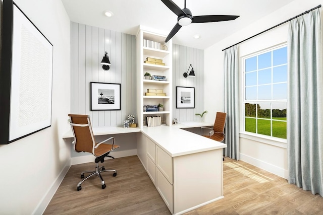 office featuring ceiling fan, light wood-type flooring, and built in desk