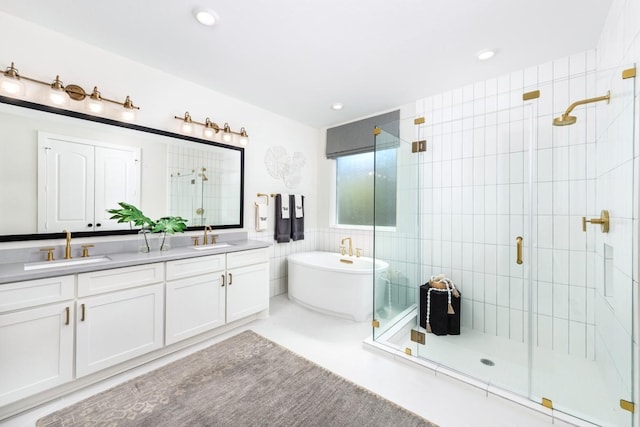 bathroom featuring vanity, shower with separate bathtub, and tile walls