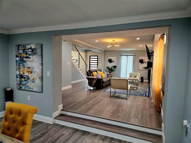 living room featuring crown molding, a chandelier, and dark hardwood / wood-style floors