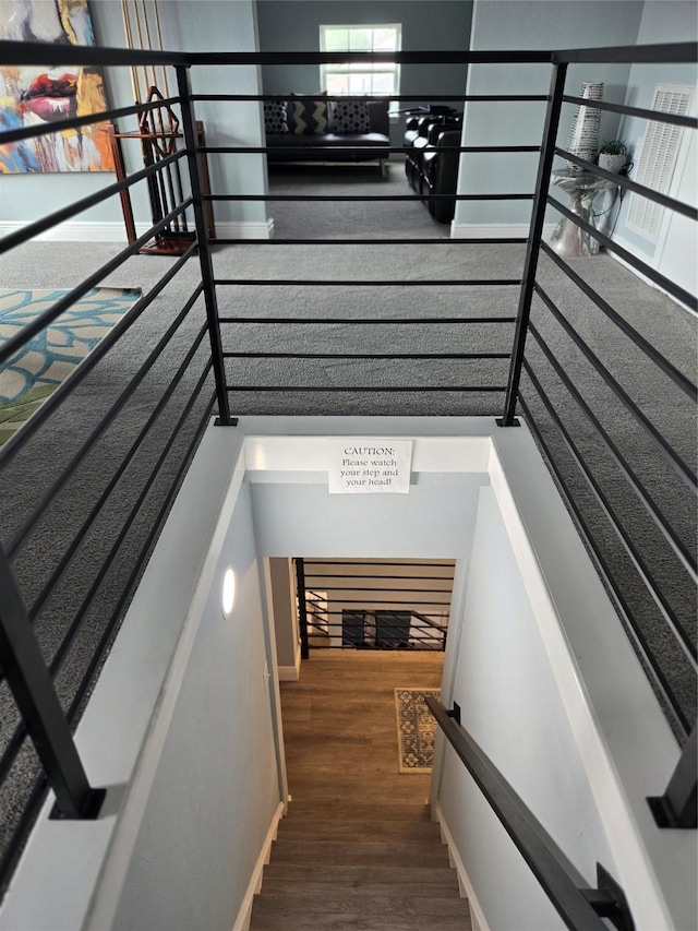 staircase with hardwood / wood-style flooring