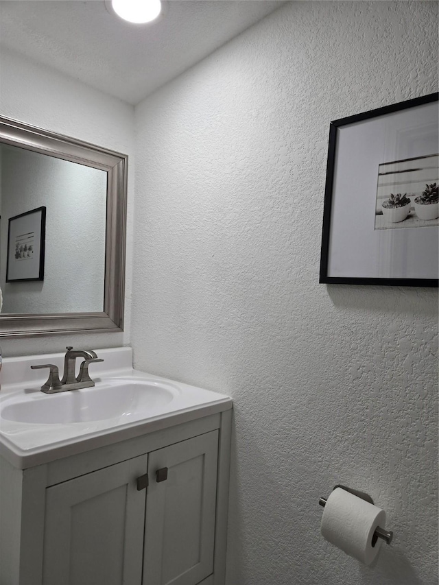 bathroom featuring a textured ceiling and vanity