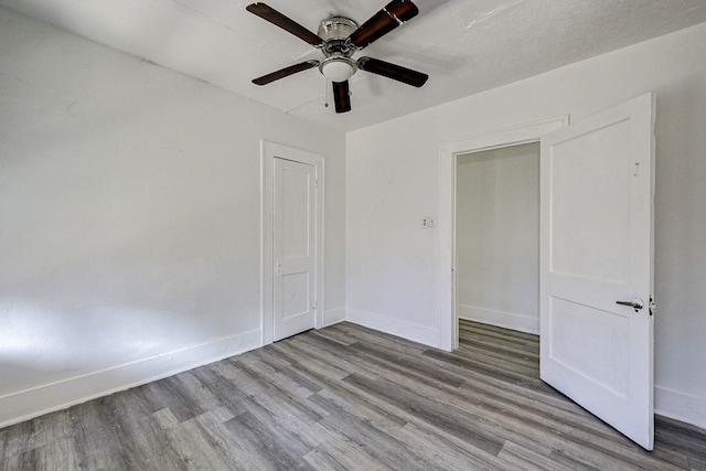 unfurnished room featuring light hardwood / wood-style floors and ceiling fan