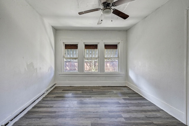 unfurnished room with ceiling fan, dark hardwood / wood-style flooring, and a baseboard heating unit