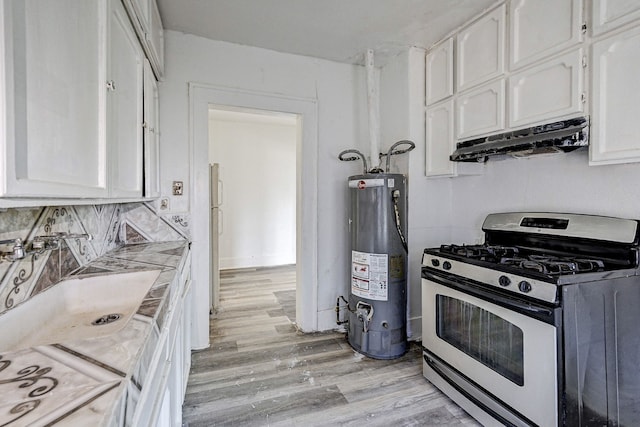 kitchen featuring tasteful backsplash, gas water heater, light hardwood / wood-style floors, white cabinetry, and range with gas stovetop