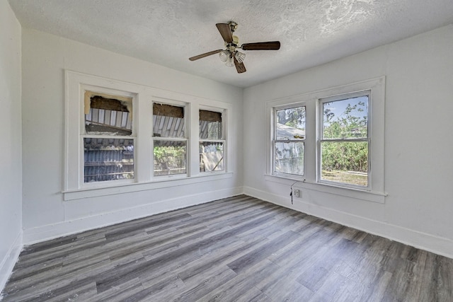 unfurnished room featuring ceiling fan, a textured ceiling, and hardwood / wood-style flooring