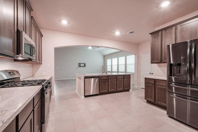 kitchen with dark brown cabinetry, ceiling fan, sink, and appliances with stainless steel finishes