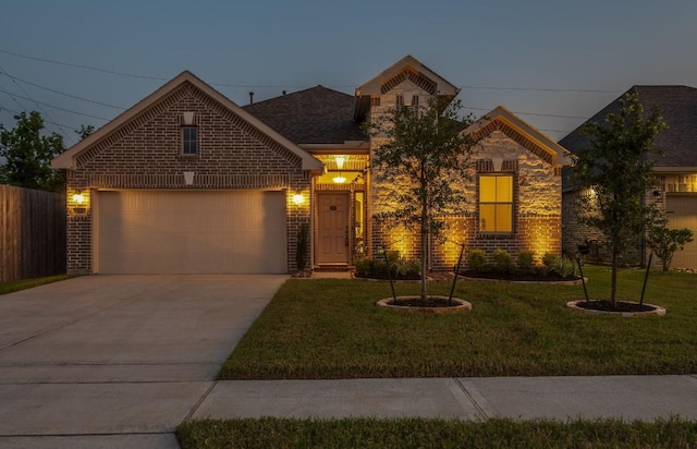 view of front of house featuring a yard and a garage