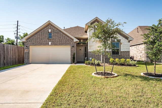 view of front of house featuring a garage and a front lawn