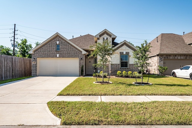 view of front of home with a front yard and a garage