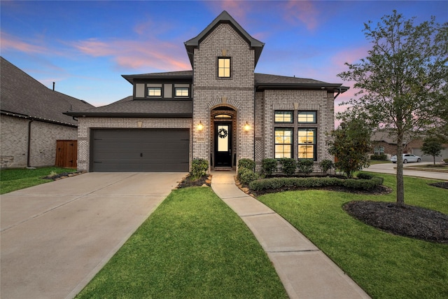 view of front facade with a garage and a yard