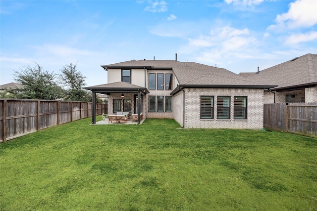 rear view of property with a lawn, a patio area, and outdoor lounge area